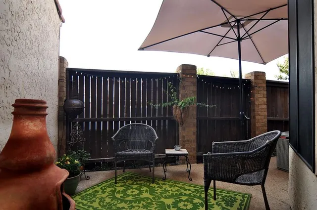 a view of balcony with two chairs and a umbrella
