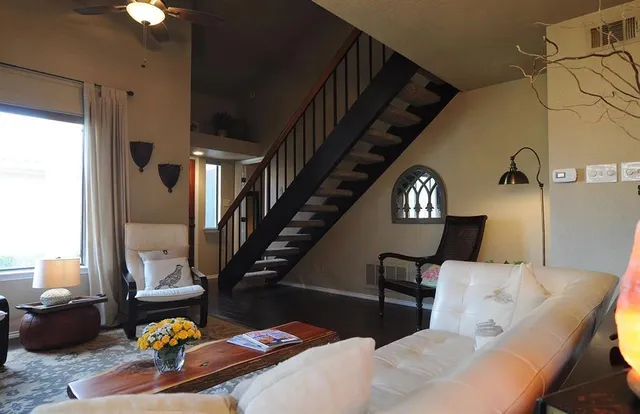 a living room with furniture fireplace and dining area