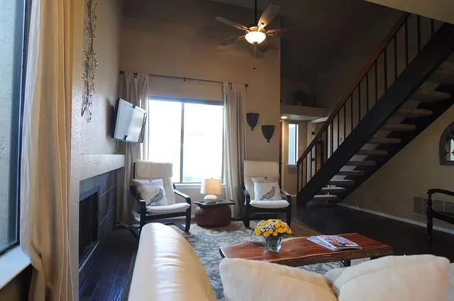 a living room with furniture and a fireplace