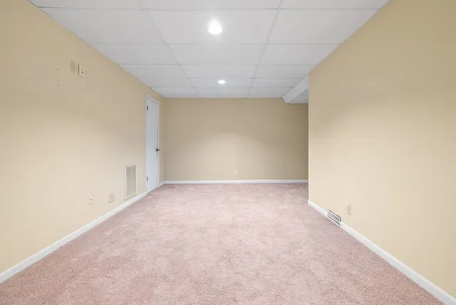 an empty room with a empty space and windows