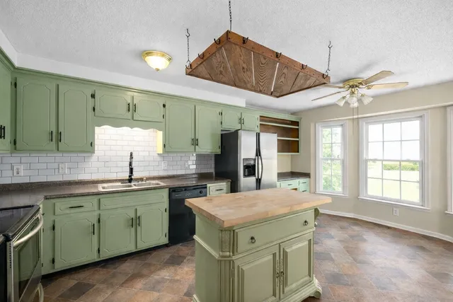a kitchen with a sink stove and cabinets