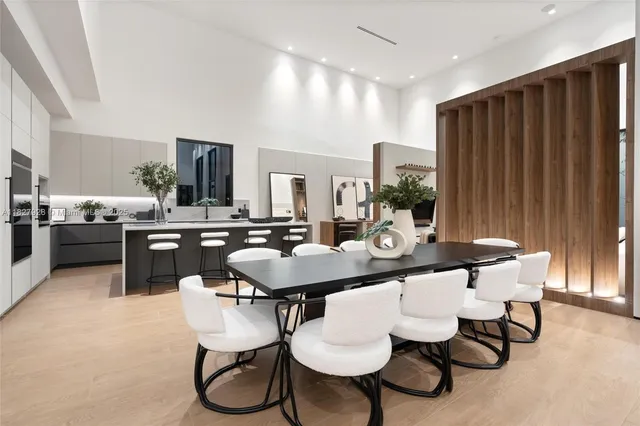 a kitchen with white cabinets and window