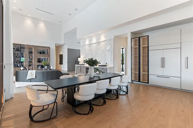 a large white bed sitting in a bedroom next to a window