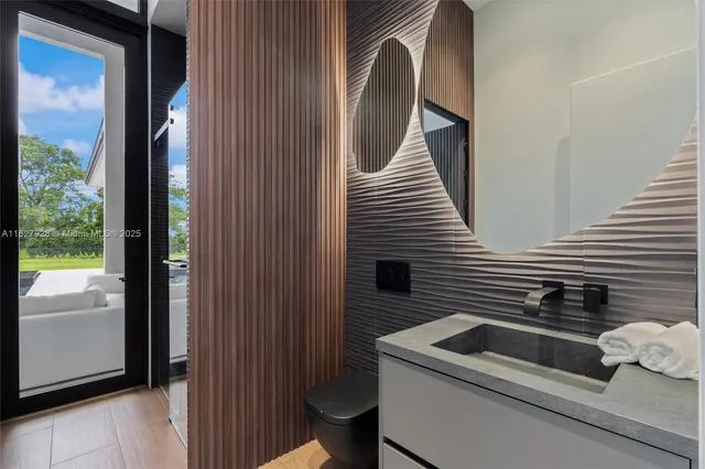 a bedroom with a bed and a dresser with mirror