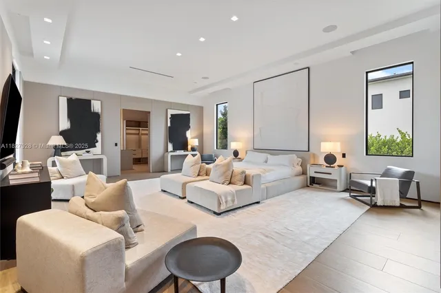 a bedroom with a bed and a large window