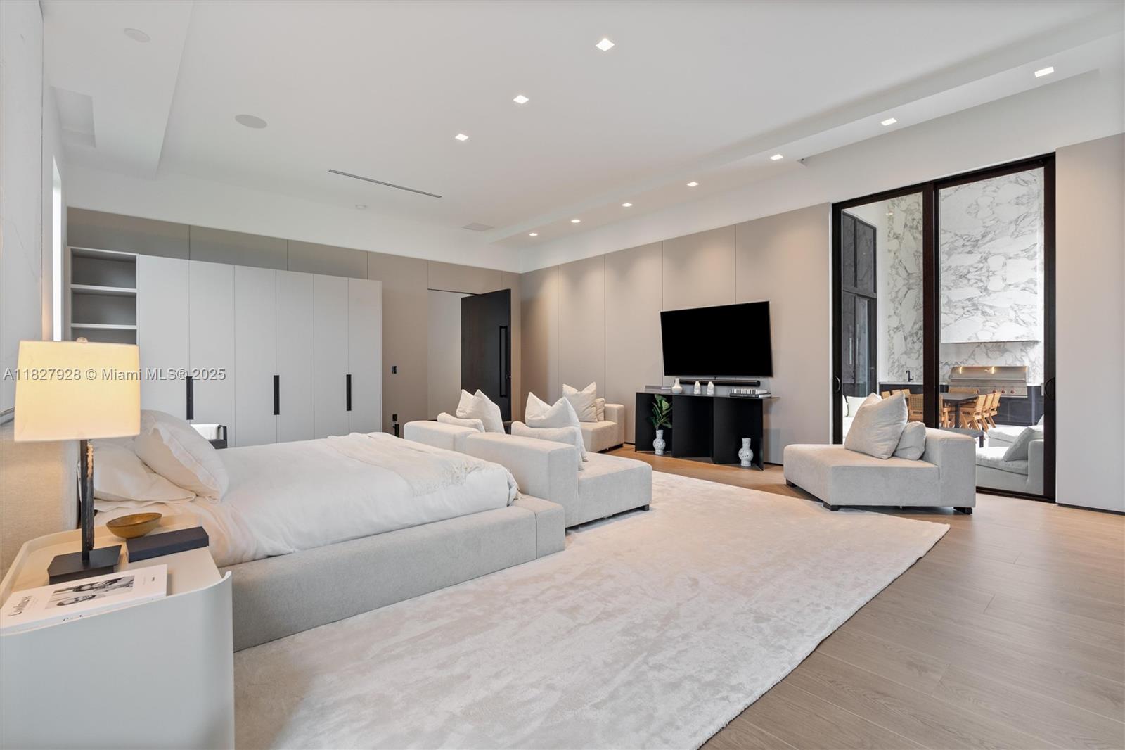 1520 Southwest 149th Terrace Fort Lauderdale, FL 33325 - Photo 35 of 80 a large bedroom with a large bed and a flat tv screen on dresser