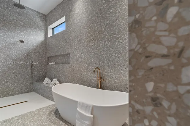 a view of an empty room and a bathroom