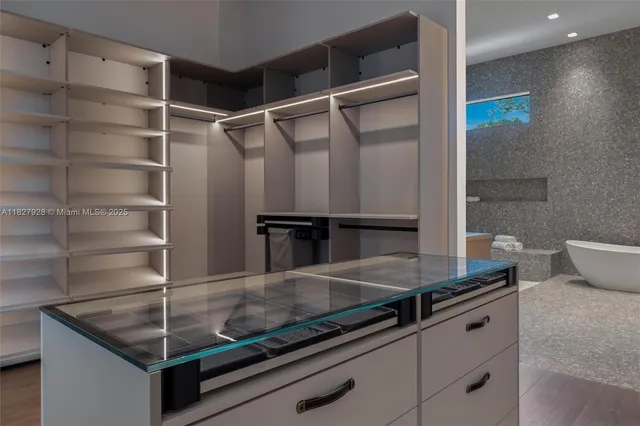 a dining room with furniture and large windows