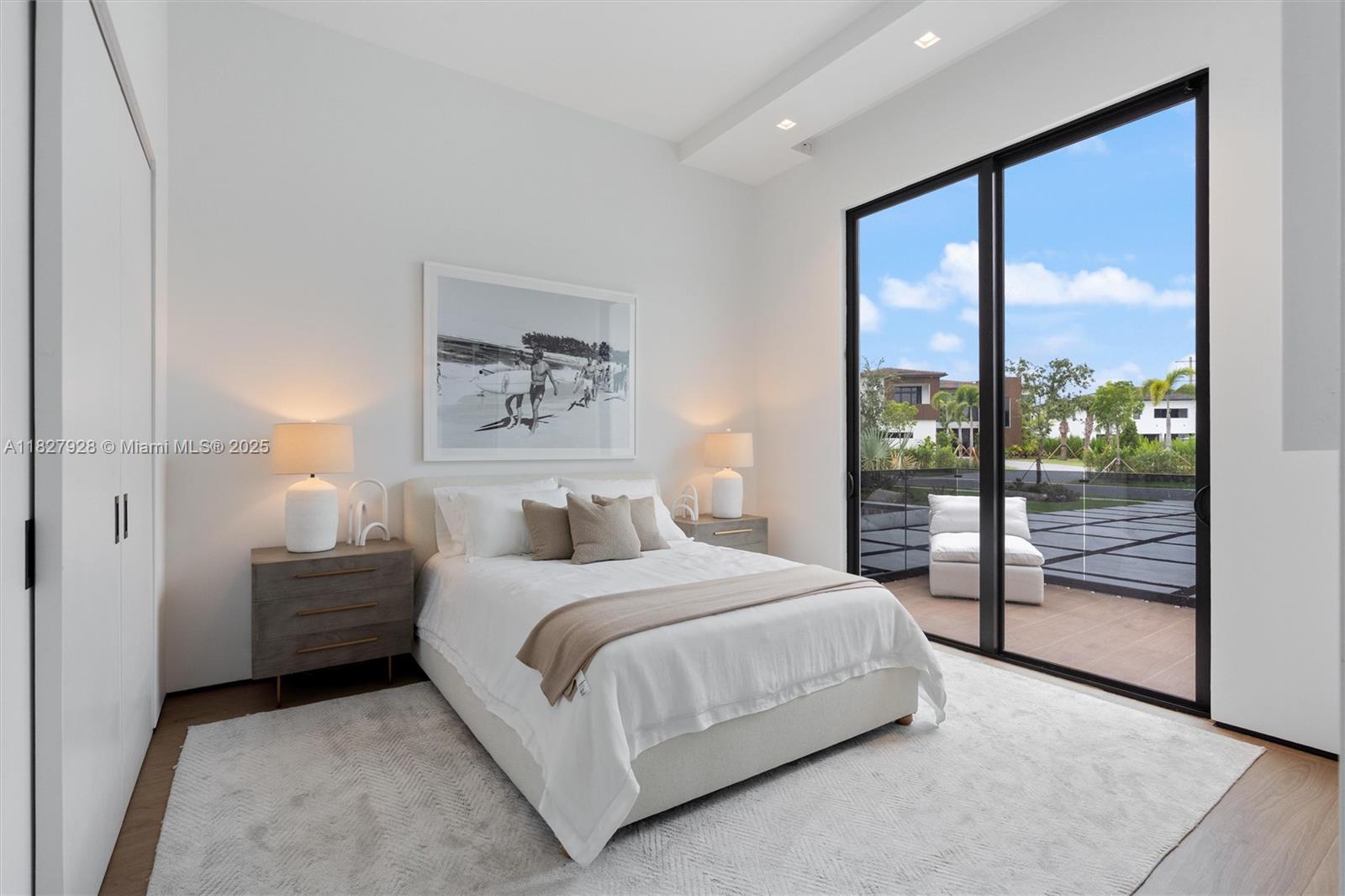 1520 Southwest 149th Terrace Fort Lauderdale, FL 33325 - Photo 43 of 80 a bedroom with a balcony a bed and a painting on the wall