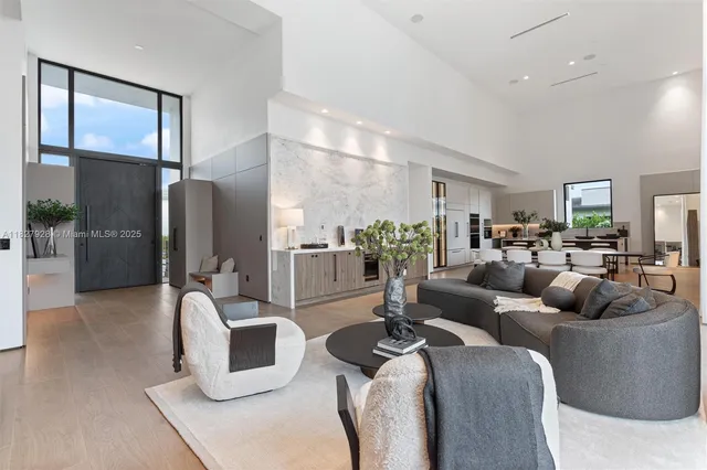 a living room with furniture and large windows