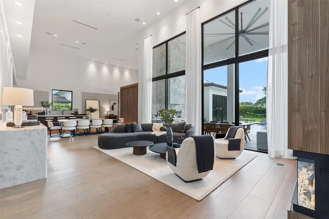 a living room with furniture large window and flat screen tv