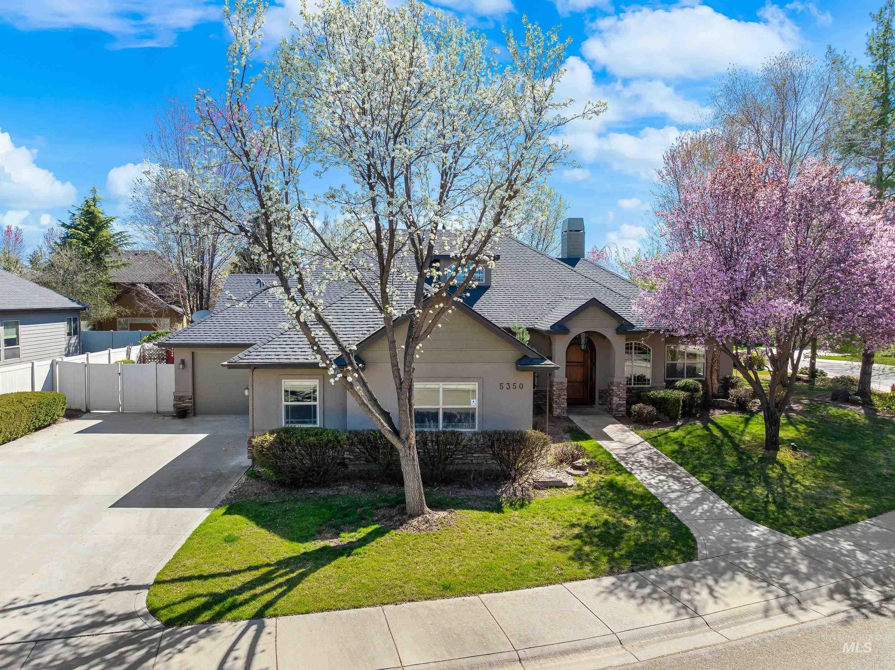 5350 North Brook Mist Place Boise, ID 83713 - Photo 1 of 1 View of front of house featuring a chimney, stucco siding, stone siding, and driveway