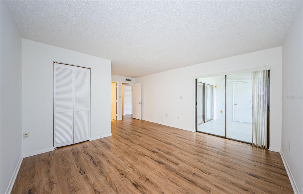 2650 Countryside Boulevard, Unit F110 Clearwater, FL 33761 - Photo 12 of 26 a view of an empty room with wooden floor