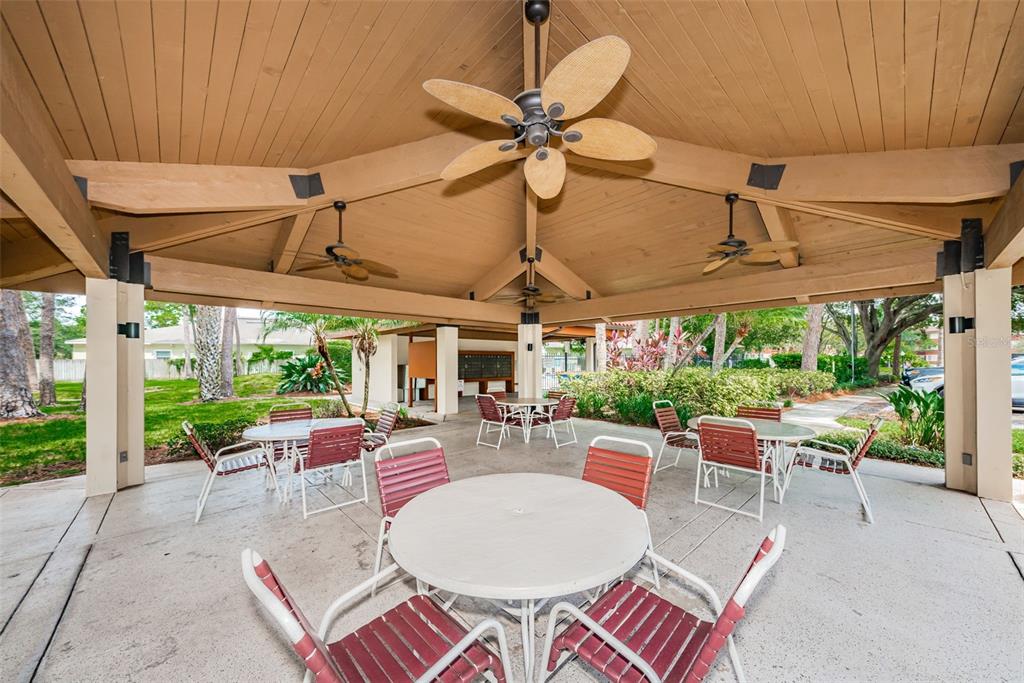 2650 Countryside Boulevard, Unit F110 Clearwater, FL 33761 - Photo 22 of 26 a view of a patio with a table and chairs