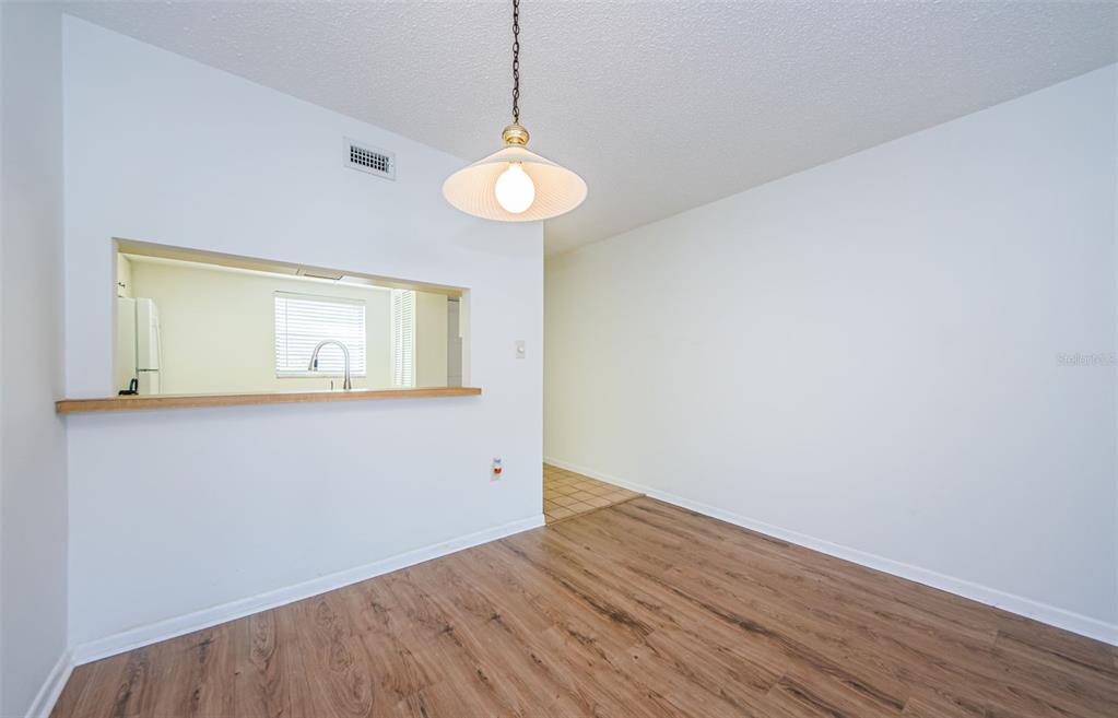 2650 Countryside Boulevard, Unit F110 Clearwater, FL 33761 - Photo 9 of 26 a view of empty room with wooden floor and fan