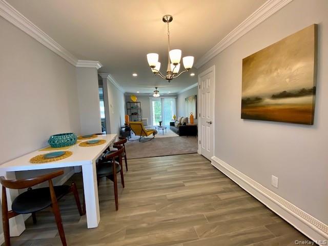 524 Terrace Road, Unit T14524 Bayport, NY 11705 - Photo 6 of 11 a view of a dining room with furniture and wooden floor