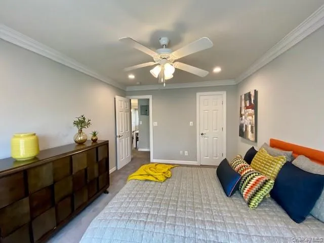 a spacious bedroom with a bed and a chandelier