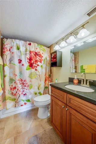 a bedroom with a bed window and a chandelier