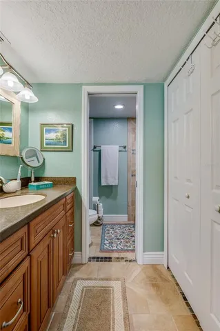 a spacious bathroom with a sink a mirror and a shower