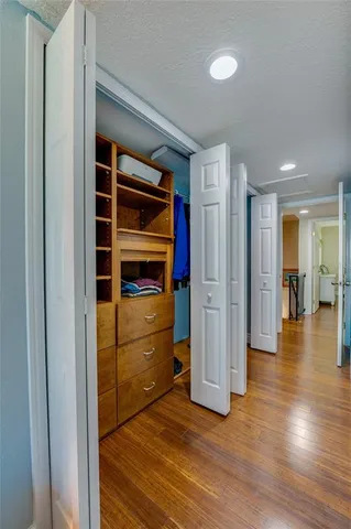 a spacious bathroom with a granite countertop sink a toilet and a mirror