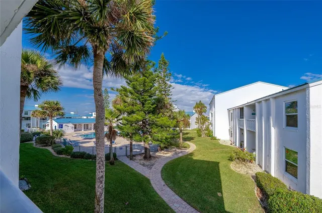 a view of a house with backyard and porch