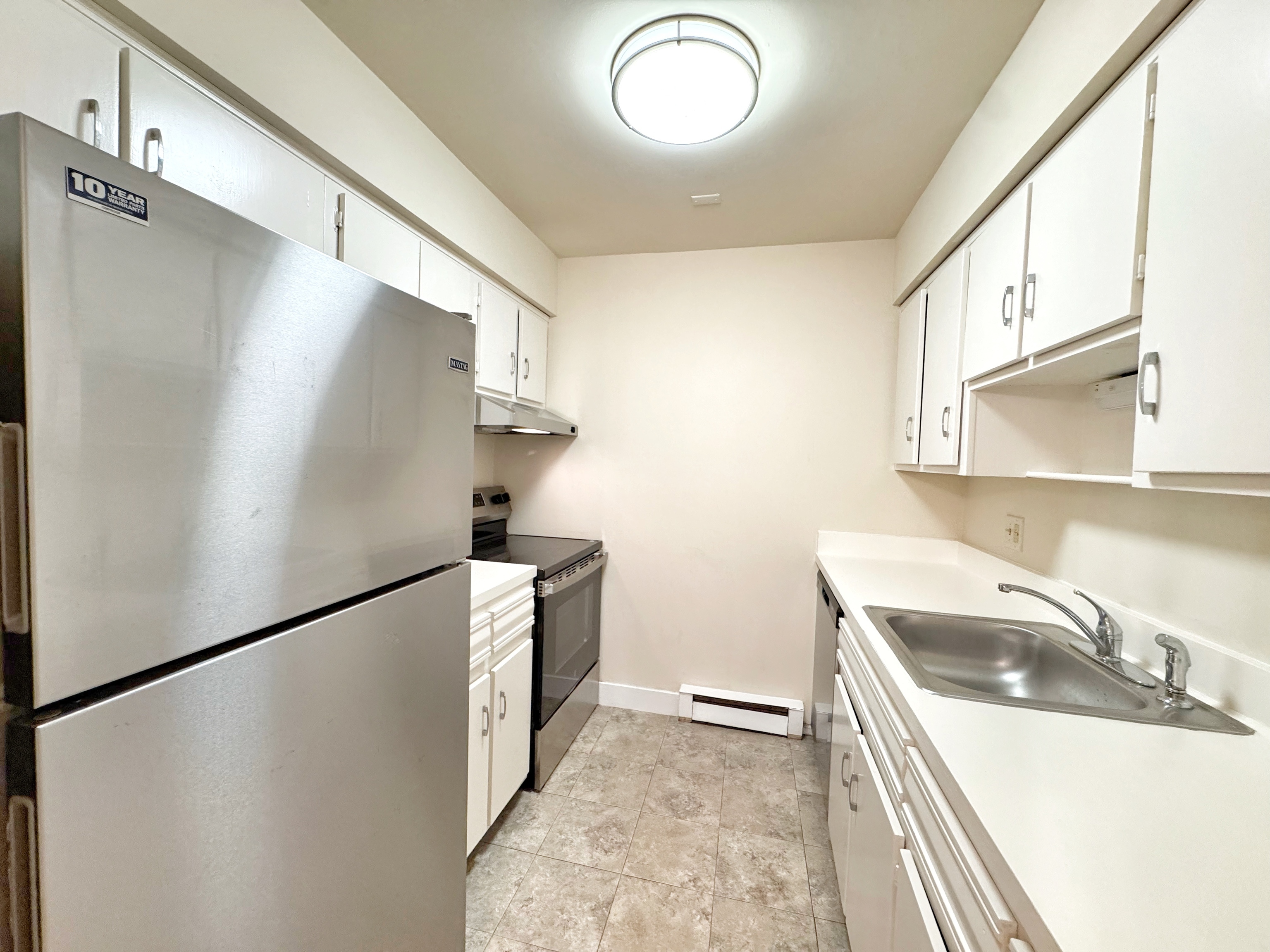 24 Ferris Avenue, Unit 4 Norwalk, CT 06854 - Photo 1 of 12 a kitchen with a sink and a refrigerator