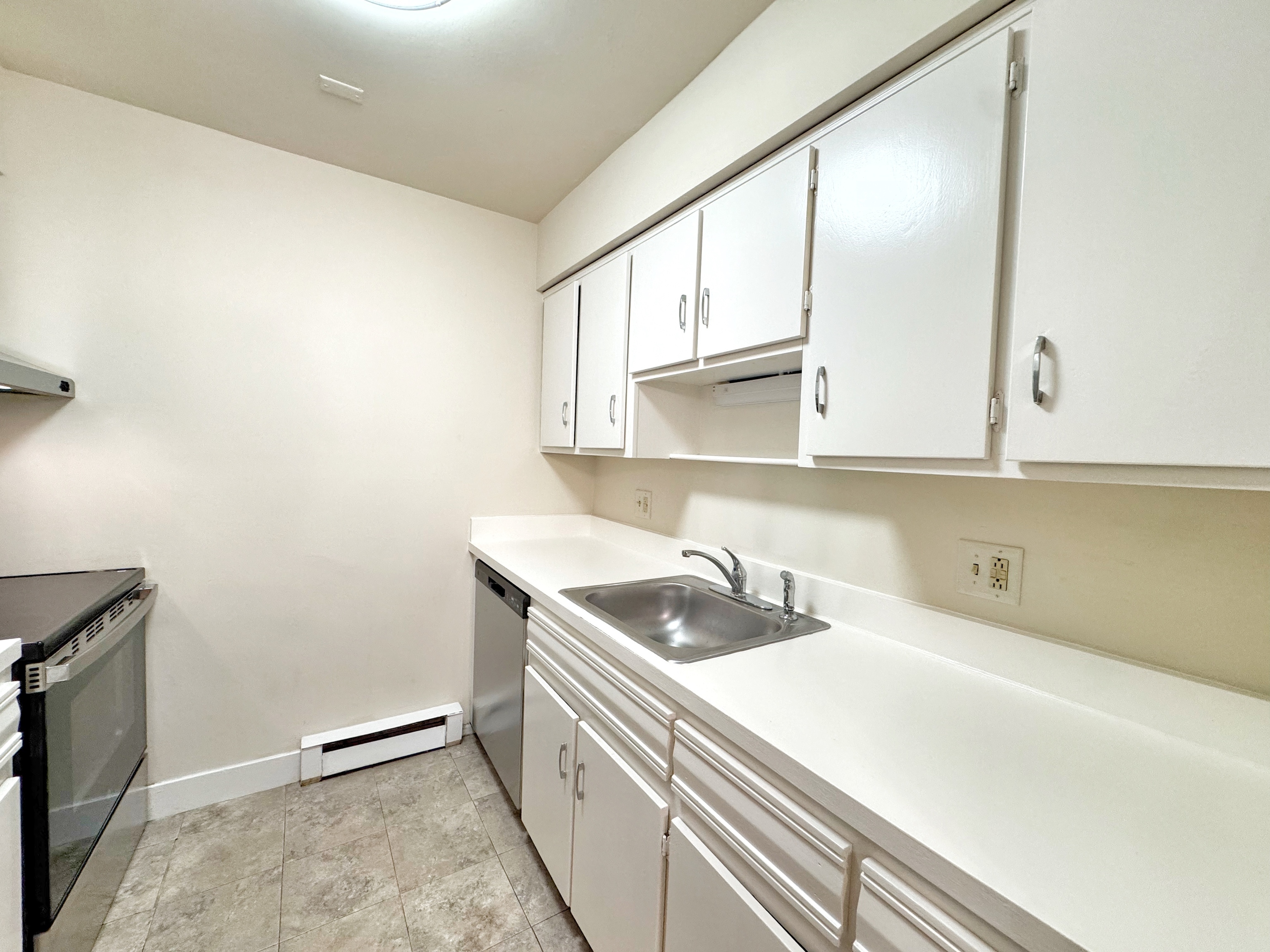24 Ferris Avenue, Unit 4 Norwalk, CT 06854 - Photo 3 of 12 a kitchen with a sink and cabinets