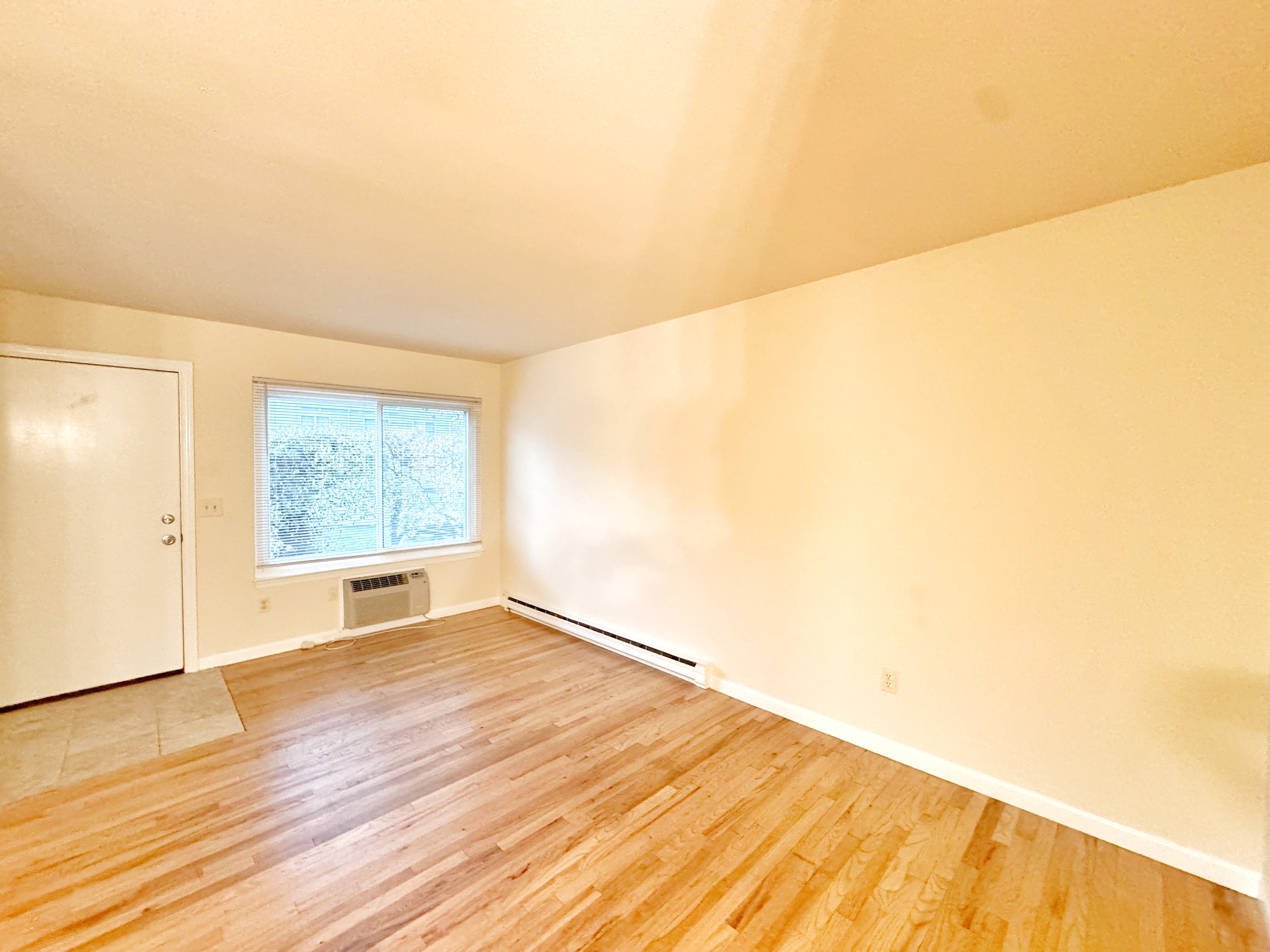 24 Ferris Avenue, Unit 4 Norwalk, CT 06854 - Photo 5 of 12 an empty room with wooden floor and windows