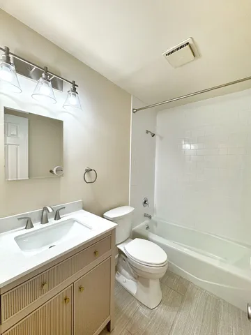 a bathroom with a sink toilet a mirror and shower