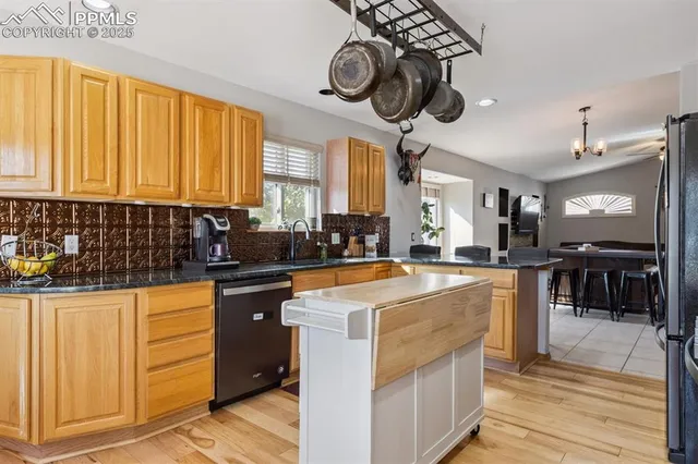 a kitchen with stainless steel appliances granite countertop a sink and cabinets