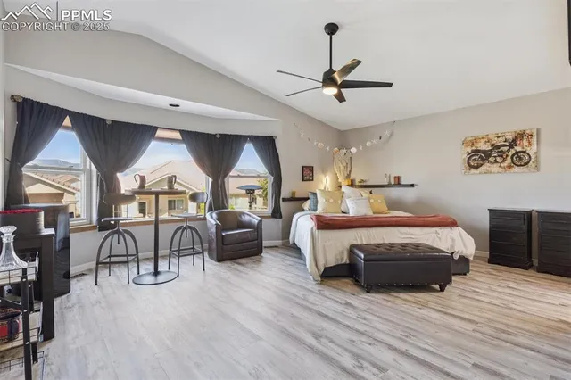 a bedroom with furniture and a wooden floor