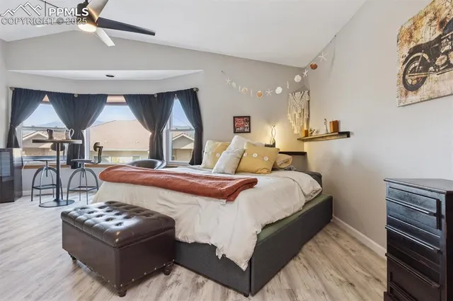 a bedroom with a bed couch and window