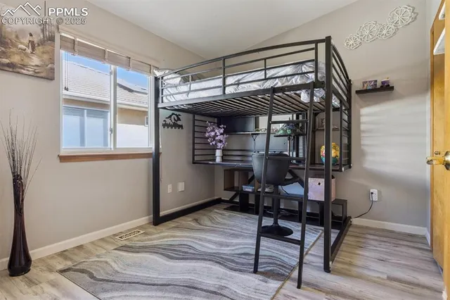 a bedroom with bunk bed and a window