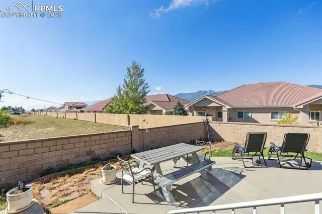 a view of a terrace with couches and lounge chairs