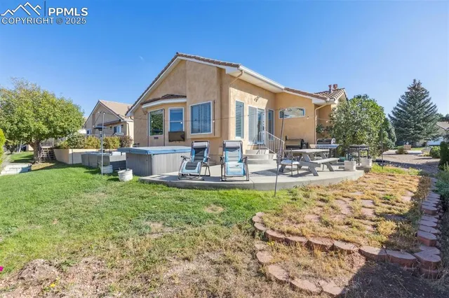 a view of a house with backyard porch and sitting area