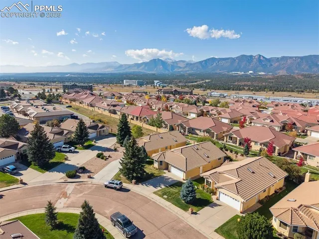 an aerial view of residential houses with outdoor space and mountain view