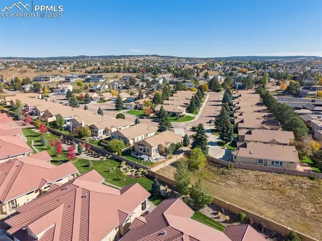 an aerial view of a house with a yard