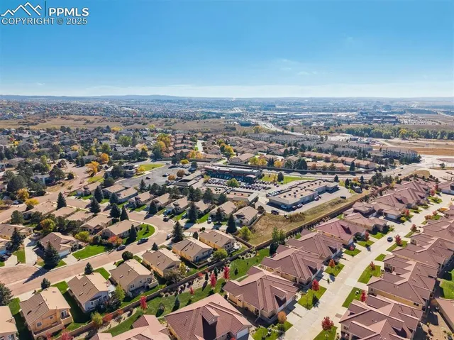 an aerial view of residential building with yard