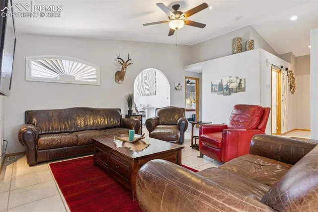 a living room with furniture a rug and a window