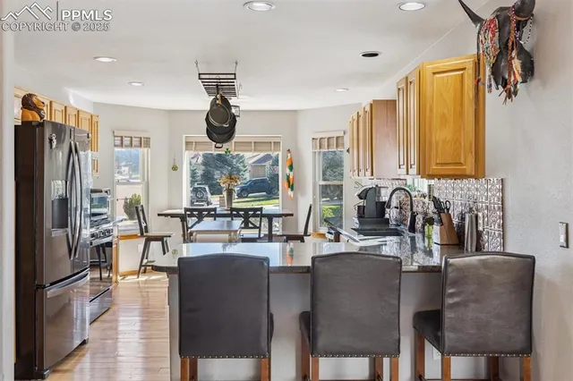 a dining room with furniture a chandelier and window