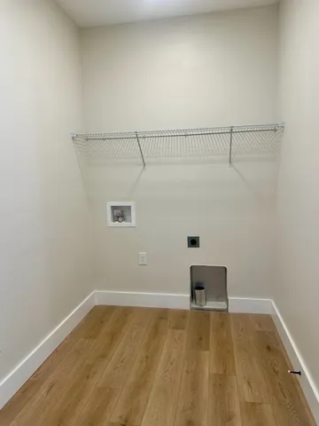 a view of a room with wooden floor