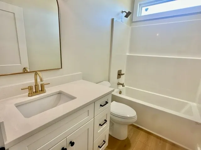 a bathroom with a sink a toilet and a bathtub