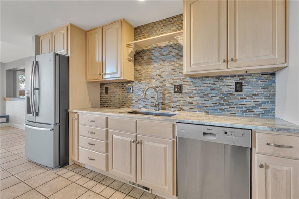 685 Old Ridge Road Avella, PA 15312 - Photo 8 of 50 a kitchen with stainless steel appliances granite countertop a refrigerator sink and cabinets