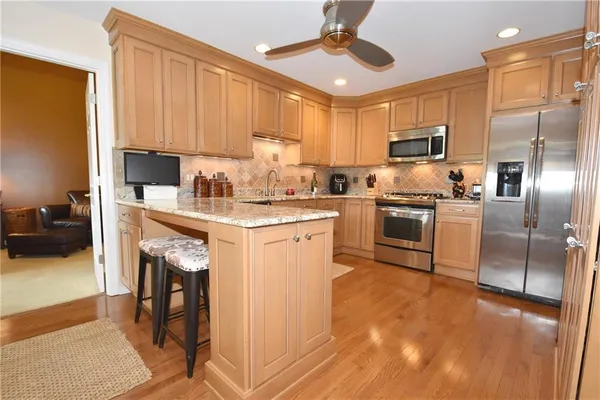 a kitchen with a sink stainless steel appliances and white cabinets
