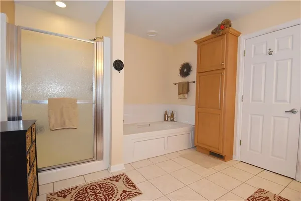 a bathroom with a tub shower and sink