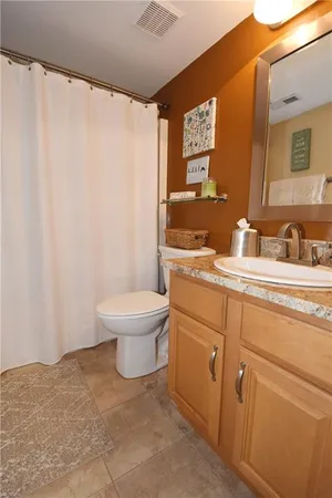 a bathroom with a toilet a sink and a mirror