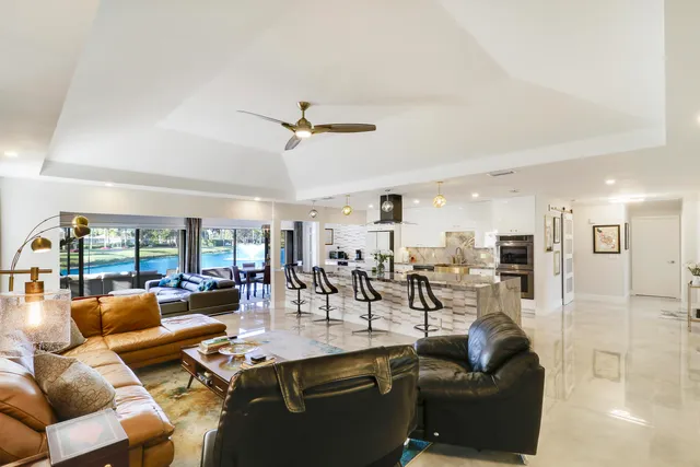 an aerial view of a house with swimming pool and mountains