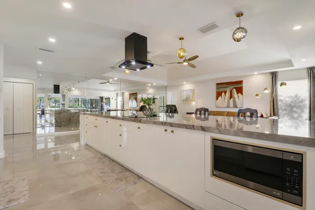 a dining room with furniture a chandelier and wooden floor