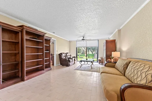 a view of a livingroom with furniture and a large window