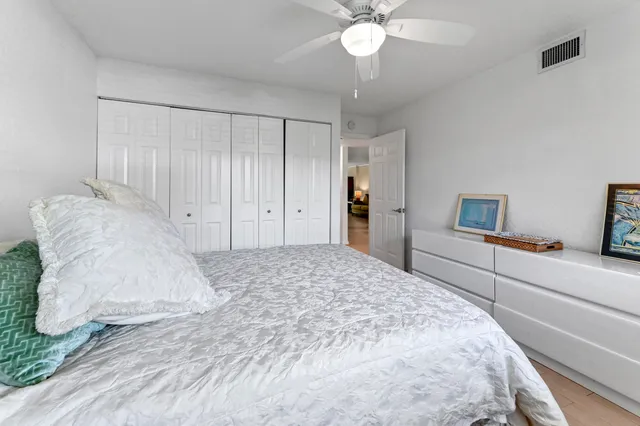 a spacious bedroom with a bed and a chandelier